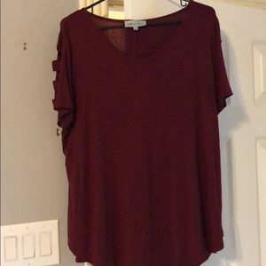 Burgundy colored tee with shoulder cut outs